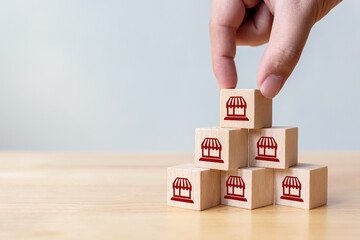 Franchise business marketing system concept. Structure service store network strategy. Hand putting...