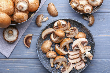 Composition with raw mushrooms on wooden background