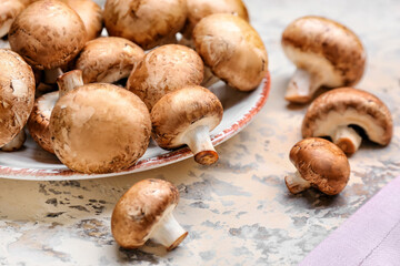 Plate with raw mushrooms on table, closeup