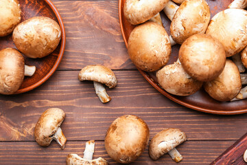 Composition with raw mushrooms on wooden background