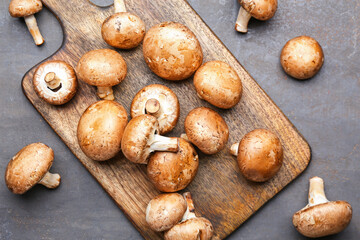 Board with raw mushrooms on table