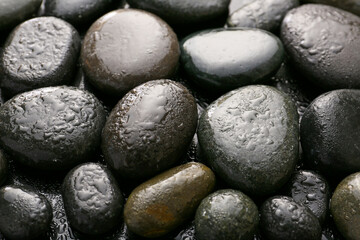 Wet spa stones on dark background