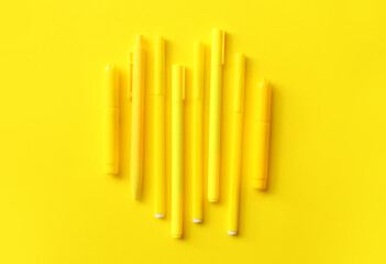 Pens and markers on color background