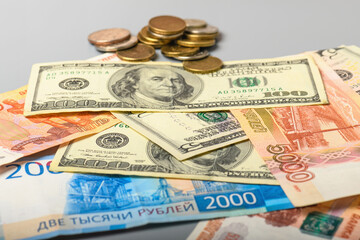 Cash banknotes and coins background. The background of the American and Russian money banknotes and coins. Dollars and rubles background.