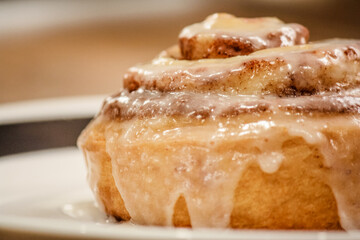 Delicious hot cinnamon roll with icing - Powered by Adobe