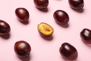 Tasty sweet plums on color background