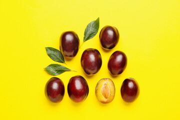Tasty sweet plums on color background