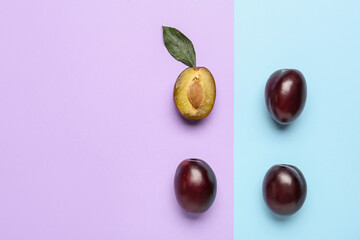 Tasty sweet plums on color background