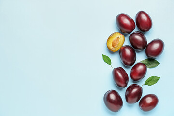 Tasty sweet plums on color background