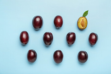 Tasty sweet plums on color background