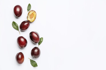 Tasty sweet plums on white background