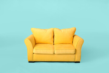 Stylish sofa on color background