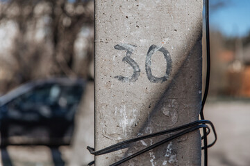 Construction cement pillar with number thirty
