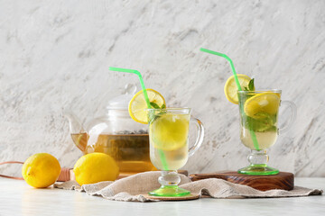 Cups of tasty cold ice tea on table