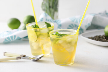 Cups of tasty cold ice tea on table