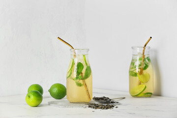 Bottles of tasty cold ice tea on white background