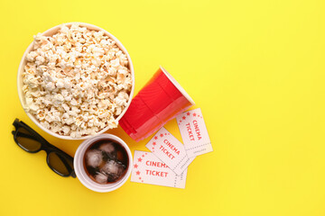 Popcorn, cola, 3D glasses and cinema tickets on color background