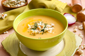 Bowl with tasty popcorn soup on table