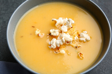 Bowl with tasty popcorn soup, closeup