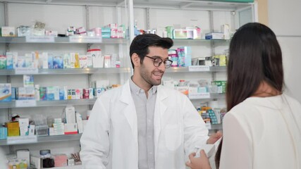 Middle eastern male pharmacist selling medications to woman patient to prescription and making drug recommendations in modern pharmacy