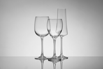 Empty glasses on grey background