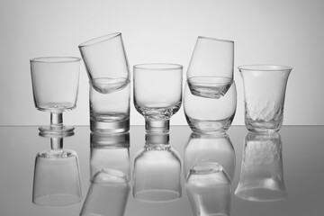 Empty glasses on grey background