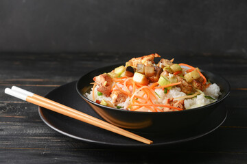 Bowl with tasty fried rice on table