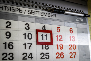 The date September 11 is highlighted on the wall calendar.