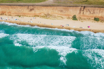 Sand beach with turquoise water. Aerial view of people on the beach. Vacation travel and relax concept