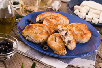 Pastry swirls with cheese and olive filling.