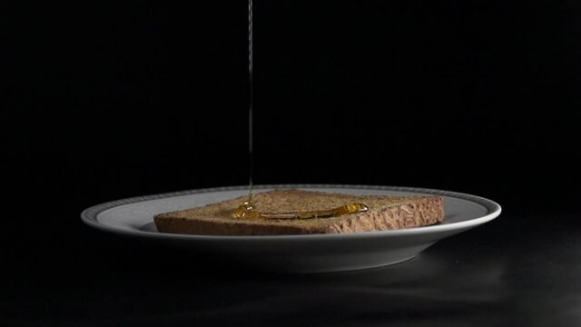 hot and toasted bread Honey drop in slow motion over