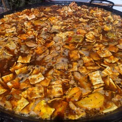 fried fish in a pan paellera paella