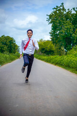 Young asian / Indian boy running on the road