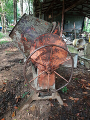 Old dirty Concrete mixer  with sand and stones