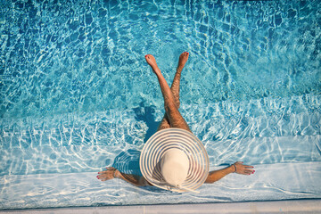 woman in luxury spa resort near the swimming pool. - obrazy, fototapety, plakaty