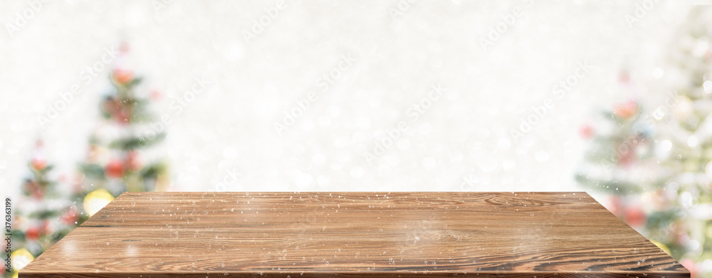Aufkleber Perspective wood table with blur Christmas tree decorate string light and blue bokeh with snow light.Panoramic wooden countertop banner mock up for product display greeting card design online content