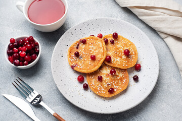 Cottage cheese pancakes with cranberries. Russian syrniki or sirniki, cottage cheese fritters or pancakes on the plate.