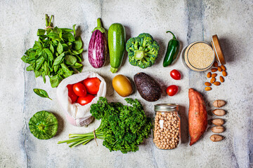 Obraz na płótnie Canvas Healthy vegan food flat lay. Fresh vegetables, fruits, nuts, quinoa, chickpeas on white background. Zero waste, vegan food, eco friendly concept.