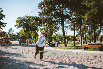 Fototapeta premium Grandmother holding a rope for a zip line