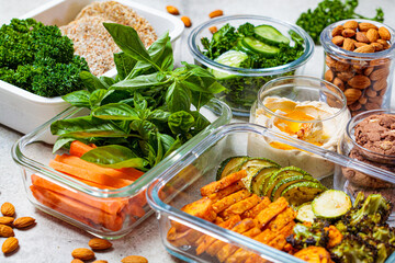 Preparing healthy meals for the week. Vegan food and snacks in glass containers.