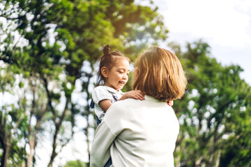 Fototapeta premium Portrait of happy grandmother and little cute girl enjoy relax together in summer park.Family and togetherness