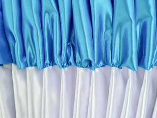 The fabric has luster, white and blue.