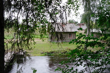 Fototapeta na wymiar chopped village bath on the Bank of the cold Northern river near the forest