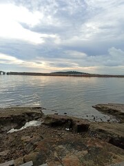 Beach view at sunset with cloudy sky
