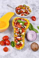 Vegan baked Butternut squash filled bell pepper, cherry tomatoes, red onion and mushrooms