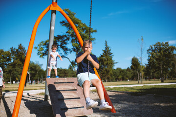 Children having fun with grandmother at the park