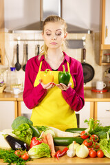 Woman holding bell peppers paprika thinking