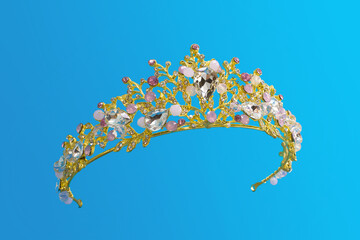 Jewellery gold crown tiara with diamonds and gemstones on blue background © axivan.com
