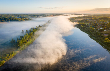 Early morning landscape. Foggy river. River valley in the morning fog at sunrise. View from above.