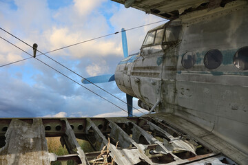 An old abandoned propeller plane stands moored forever